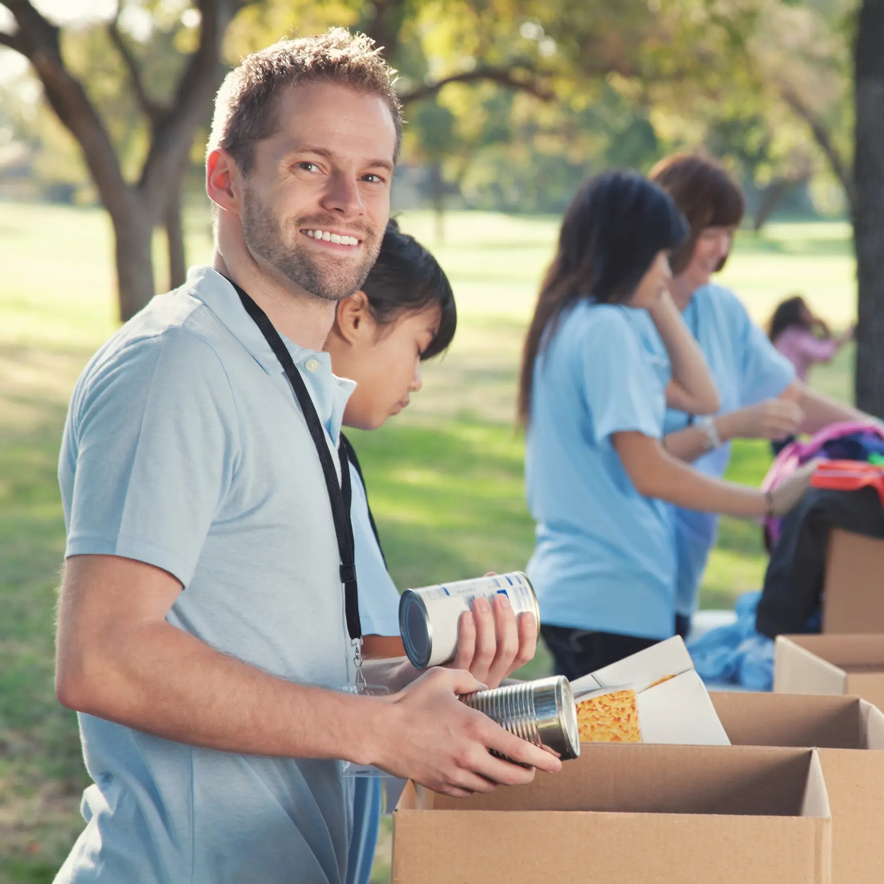 Volunteer sorting donations at outdoor event